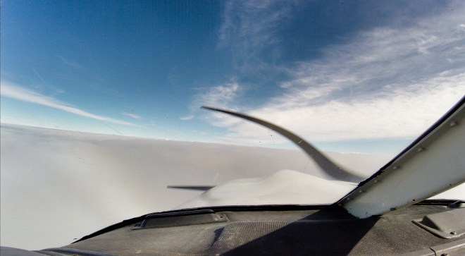 Above the sea of clouds cockpit view